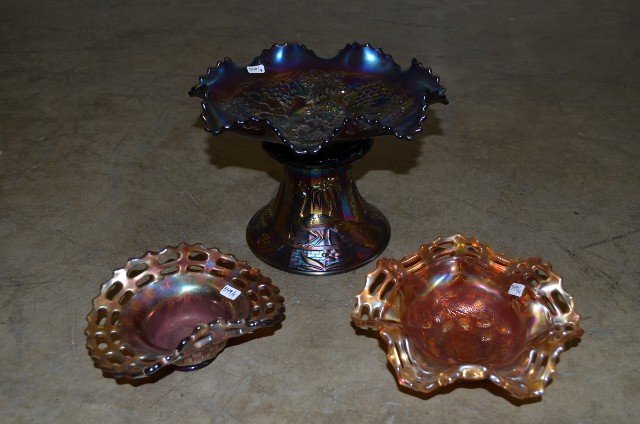 Signed Northwood Carnival Glass Pedestal and Bowl: Peacock scenes and water fountains.; a purple glass bowl with grape and oak leaf design, ruffled edges. Signed Northwood; together with two other orange carnival glass bowls. 4 1/3"h; and 9" wide