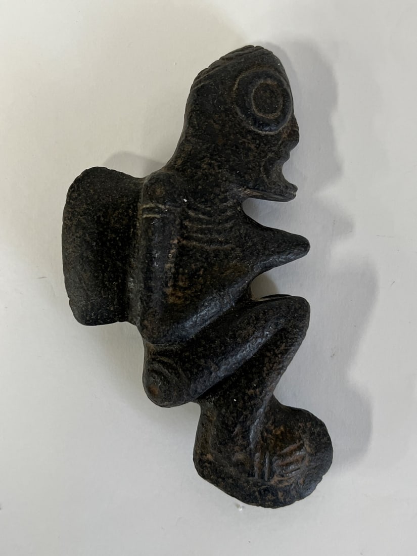 Taino Stone Ritual Object: Stone ritual object depicting a seated shaman. Caribbean Islands. Taino region. C. 900-1500 AD 6"L x 3.25"W