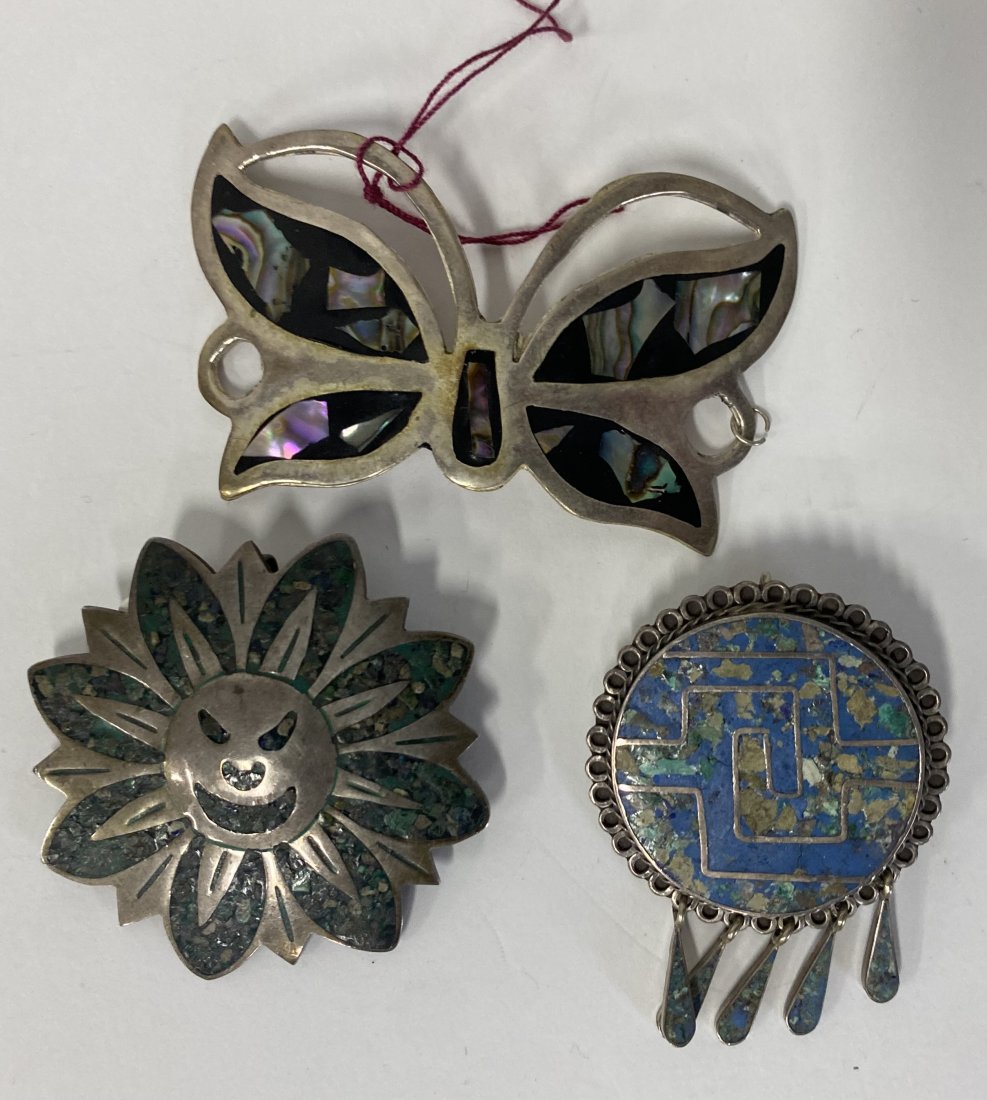 Collector or Dealer's Lot of Mexican Sterling Jewelry (3): Artist Signed Sterling silver Inlaid "Sun" brooch marked Mexico 925 and with artist's initials; sterling silver turquoise inlaid brooch with dangles marked 925 Hechoen Mexico ; large onyx and mother o