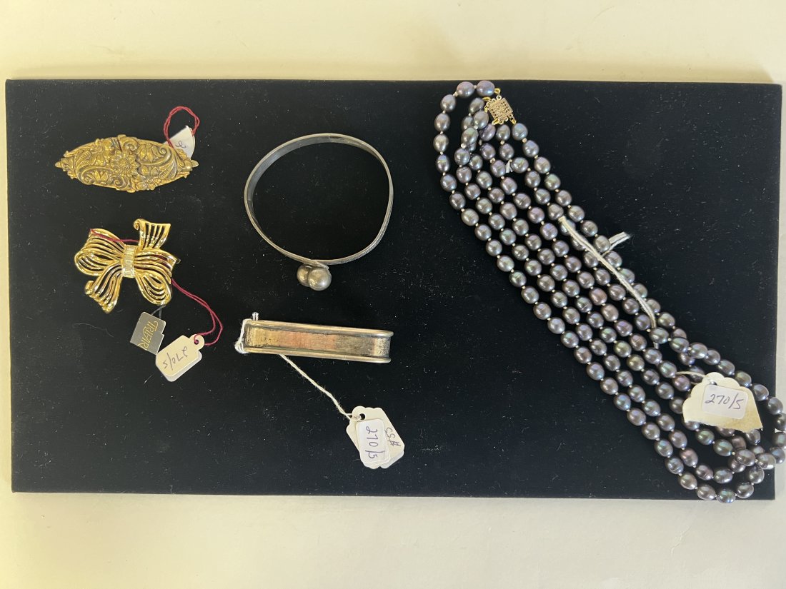 Dealer's Lot. Sgd. Trifari. Sterling N/R & Other Jewelry (5): Included in the lot is a Trifari brooch, new, never worn, signed at the backside and with the original Trifari tag; a wrap around "silver" bracelet; a Victorian repoussed brooch and a triple strand fr