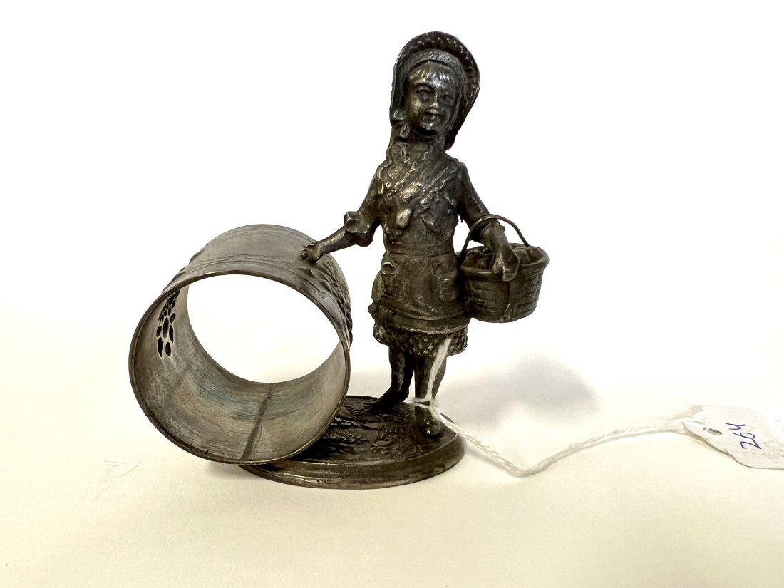 American Victorian Figural Napkin Ring: Kate Greenaway or Red Riding Hood. girl with basket stands next to napkin ring on a base resembling the earth. #d'1492