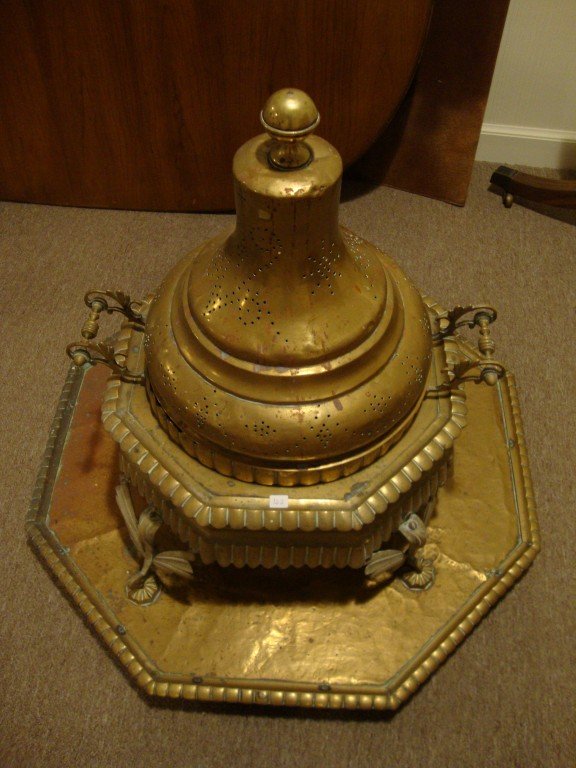 Turkish Brazier Table: Brass central portion on an octagonal brass mounted wooden base. 36"H. x 33"W
