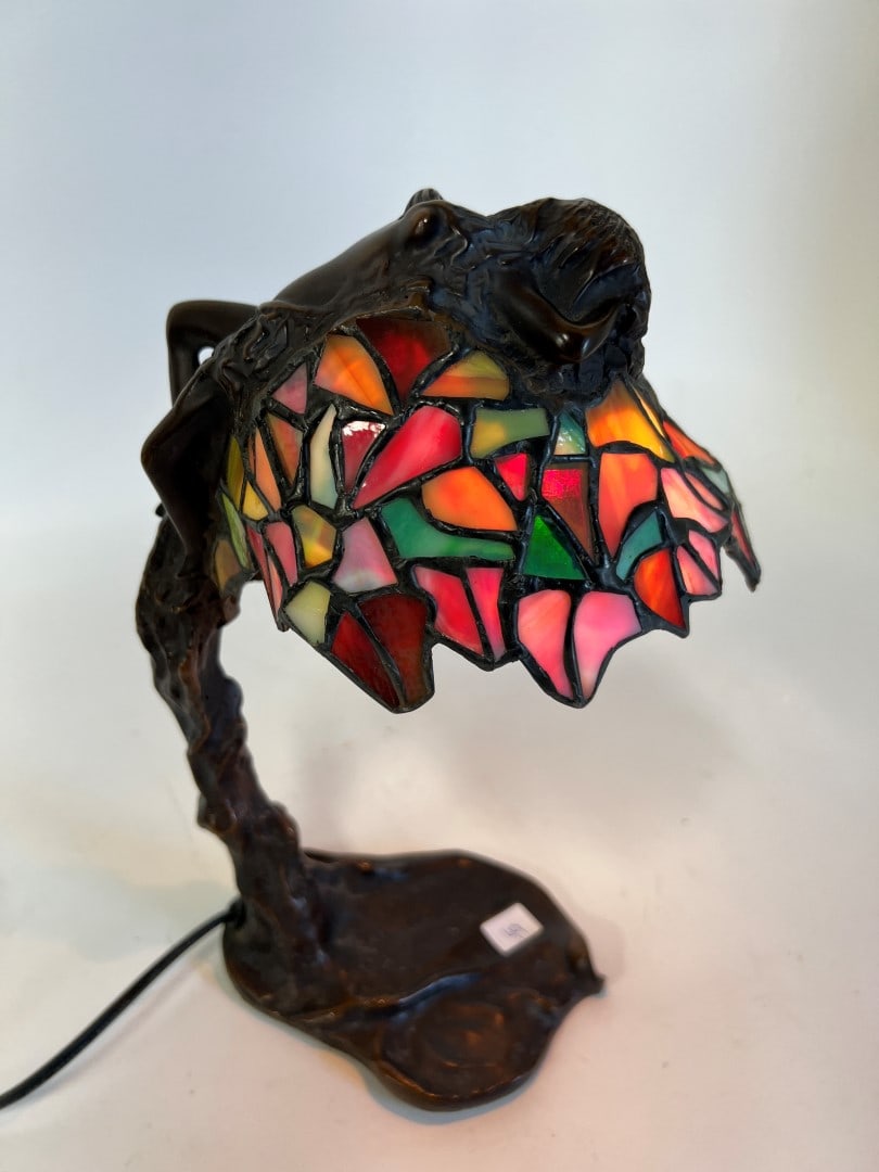 Art Deco Bronze Leaded Lamp: Reclining Nude on the top of a multi colored leaded glass shadeabove a tree trunk bas. 12 1/2"H 6"W