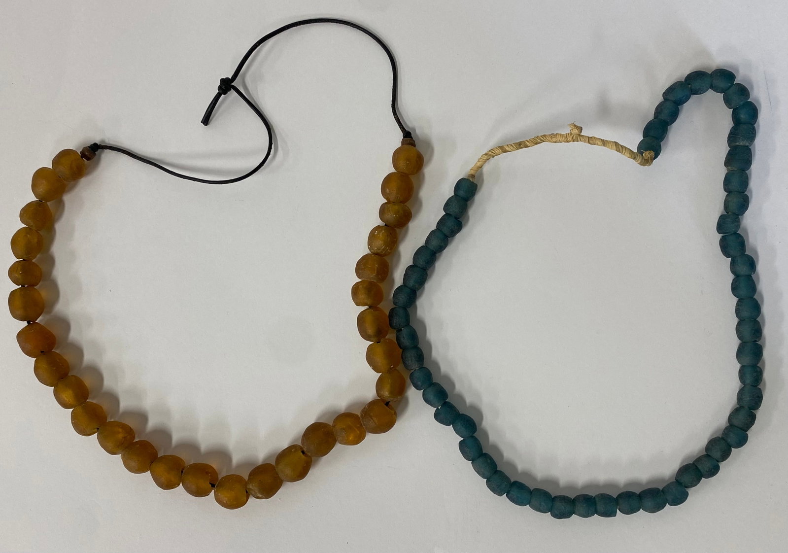 Roman African & Central European Necklaces (2): Roman, blue N. African Morocco, 3rd C. AD; yellow from Central Europe excavated at Bulgaria 200 AD. Untouched burial patina. Two necklaces in the lot.