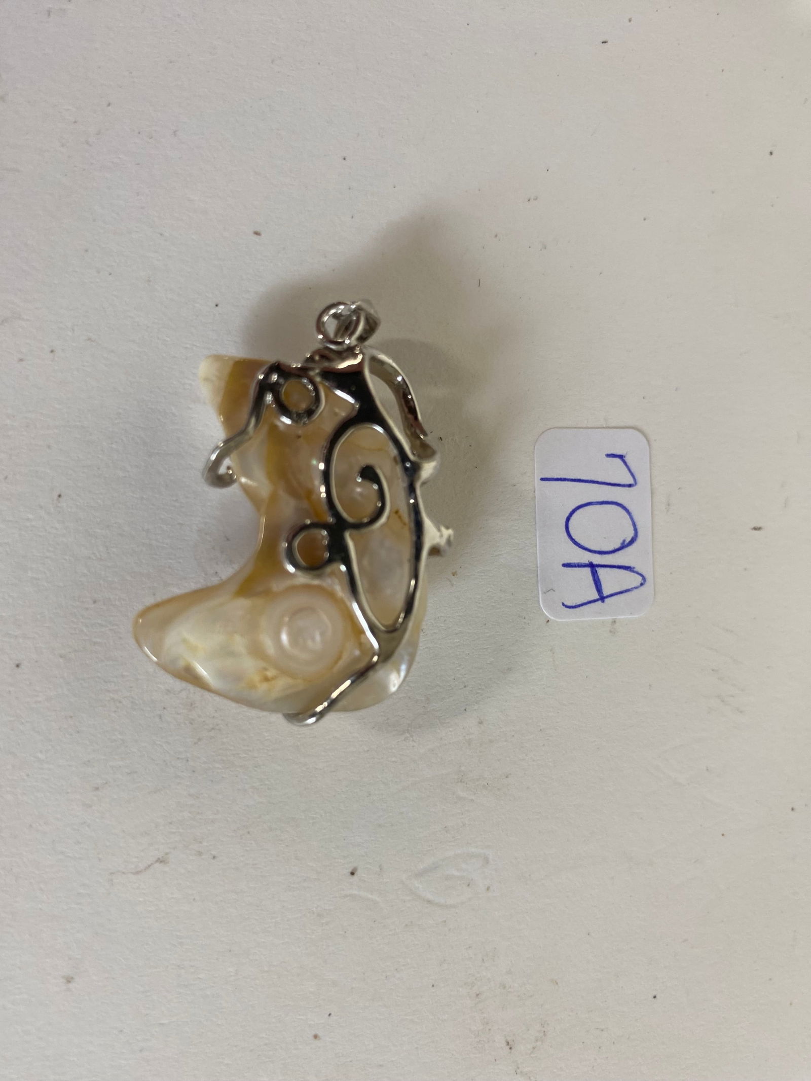 Magnificent South Sea Island Pearl: Freak of Nature abberated pearl. Great lustre, blue iridized highlights. The mount is bench crafted, Wrapped in white gold more likely titanium . A rarity, Please note: back is pictured. Front as desc