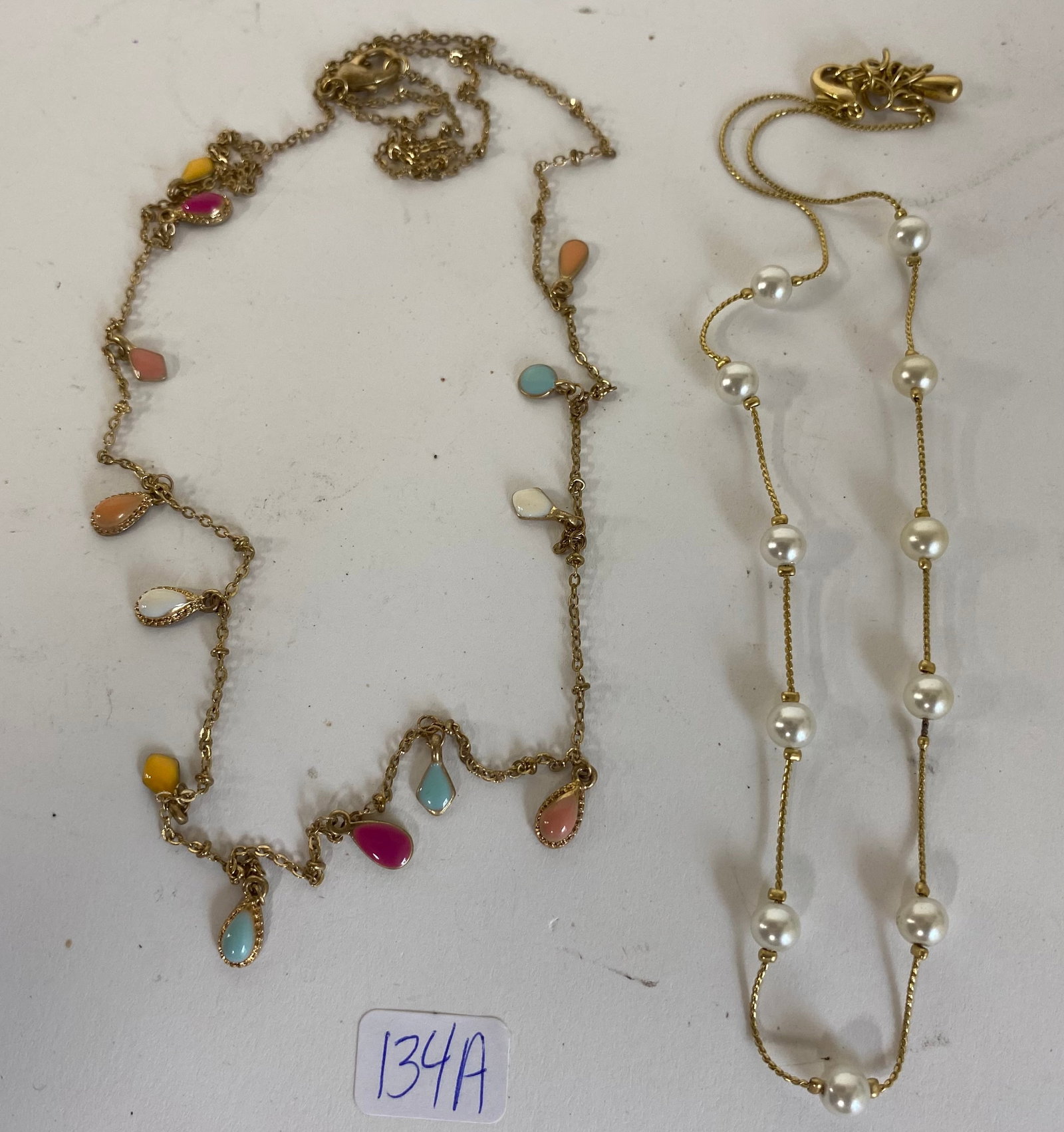 Two Antique Necklaces: Cultured pearl on "gold" chain. 34" gold vermeil chain with semi-precious and precious stones. Two in the lot
