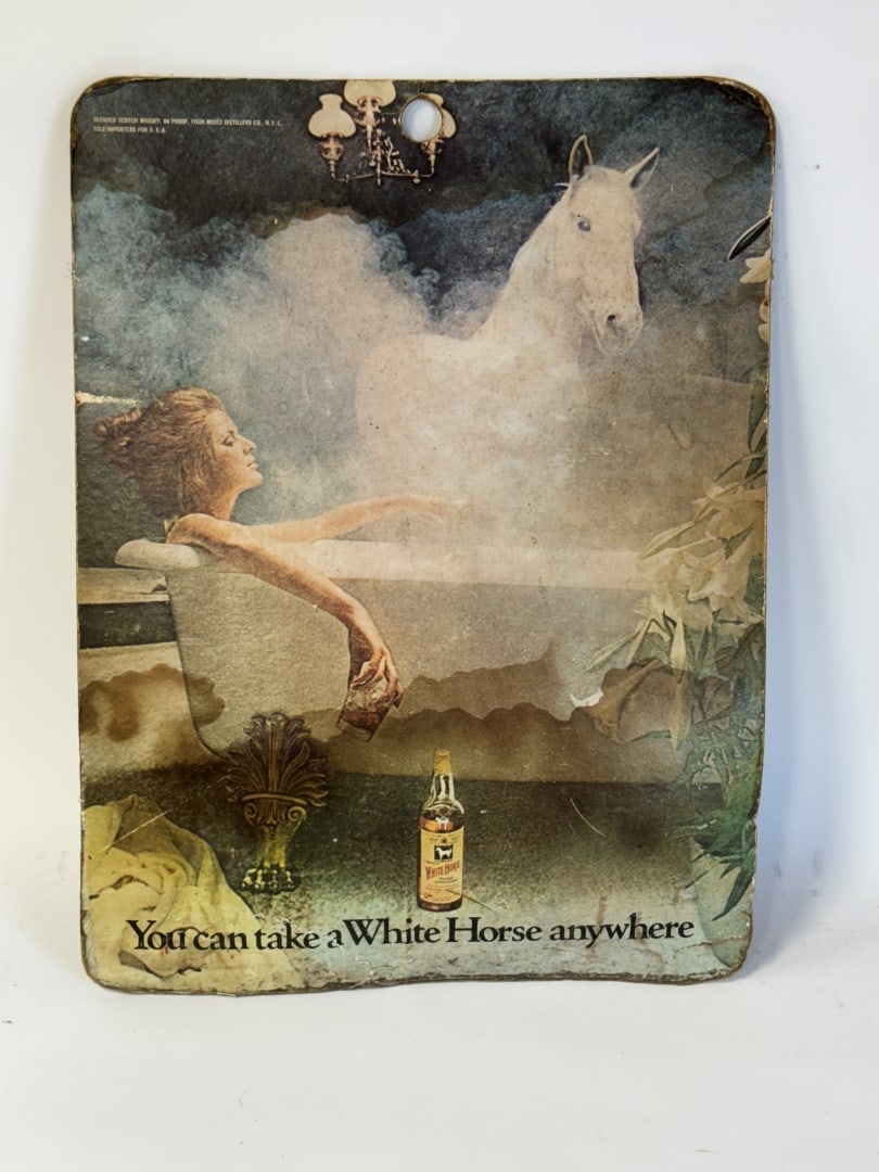 White Horse Whiskey Advertisment: On board. Featuring a woman in a bathtub and a white horse behind her. "You can take a White Horse anywhere." 23"H x 17.5"W