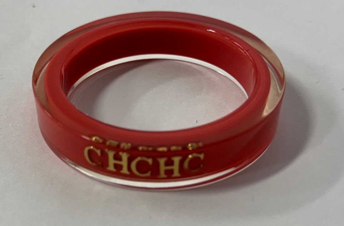 CHCHO Lucite Bracelet: Lipstick Red encased in clear lucite. Gold letters CHCHO at the front.