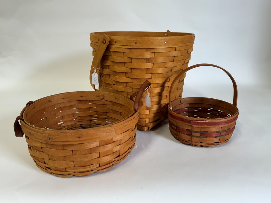 Longaberger Baskets Mkd & Dtd. (3): Marked Longaberger Hand Made Basket Hand Woven, Dresden, Ohio and sgd. LB , 1996 10 1/4"H x 11 1/4"W; 2nd one sgd the same and artist sgd. MEM and dated 1993, 4"H x 9 3/4"W; the third marked the same 