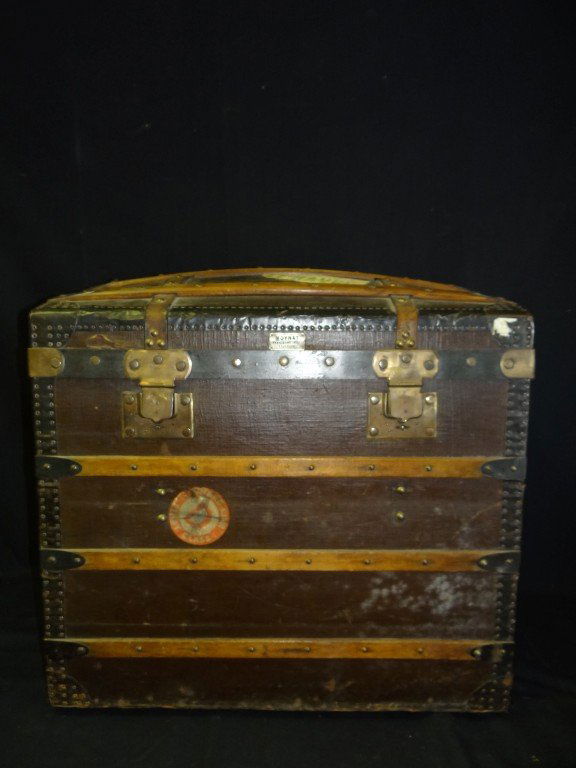 Moynat, Paris steamer Trunk: Hump top. Bound with leather and walnut bindings. Brass hardware. Original brass Moynat Paris Fabricant tag.; 27in. H. x 27.5in. W. x 18.25in. D.