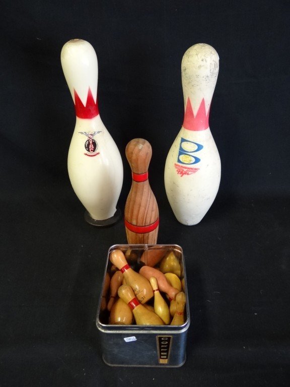 Large White Bowling Pins & Others: Two bowling pins of regulation size and bowling awards in the form of miniature pins