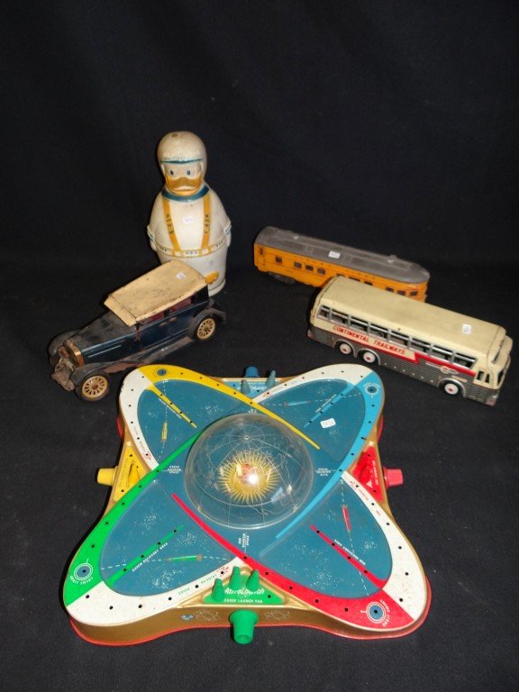 Misc. Toys and Trucks inc. Ohio Art (5): Lionel train, a Continental Trailways tin bus; a tin touring car; a Donald Duck Puppets Wheat Puffs Cereal Container by National Biscuit Co. (lid unscrews at the bottom; an Ohio Art AstroLaunch Tin Ga