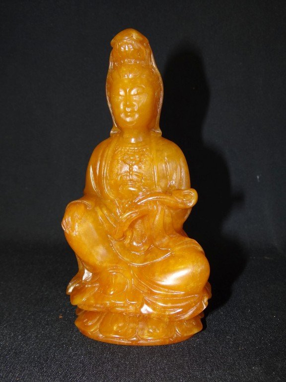 Tian huang carved Kuan Yin: Carved soapstone figure of a seated Kuan Yin. Lotus form; 6.25in. H.