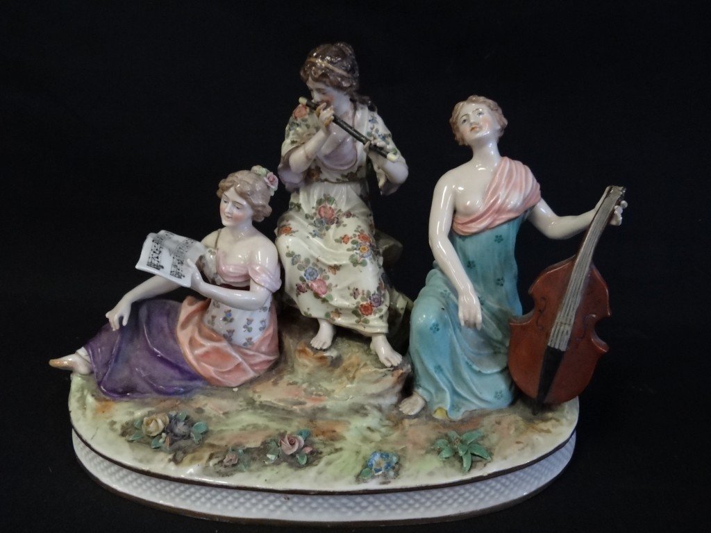 French porcelain grouping: Hand painted porcelain grouping "The Minstrels". With blue mark at bottom; 8.5in. H. x 12in. W. (as is with brak on cello and hands repaired)