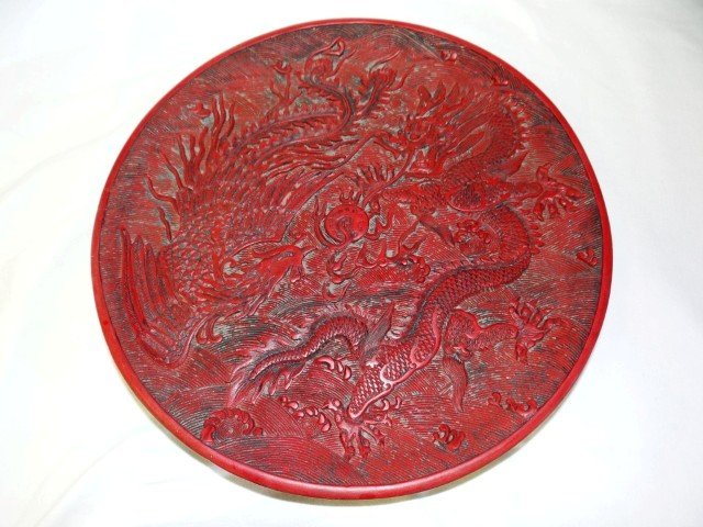 Chinese carved cinnabar charger: Carved cinnabar charger. Phoenix bird decoration. Signed; 9.75in. D.