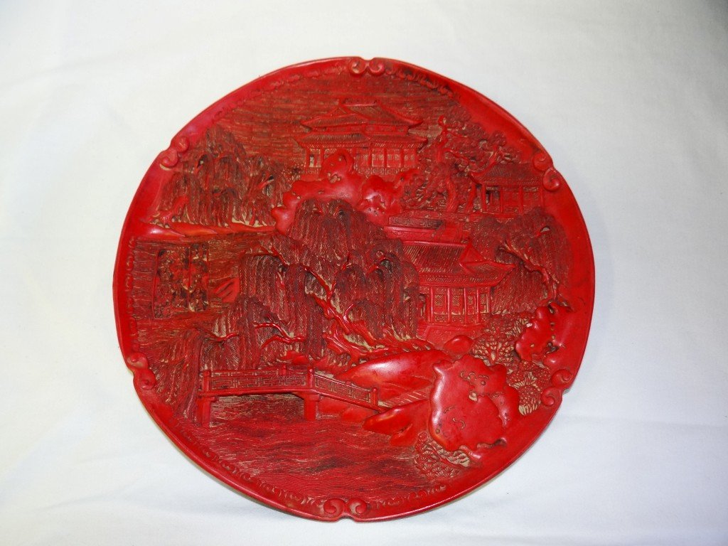 Chinese carved cinnabar charger: Carved cinnabar charger. Mountaineous village scene decoration. Signed; 9.75in. D.