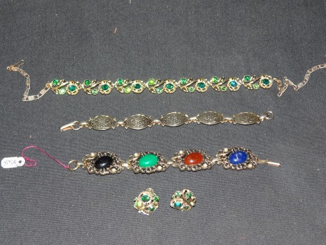 A Lot of Costume Jewelry (5): Two bracelets, a necklace with matching earrings and a sweater guard with stones Five pcs. in the lot