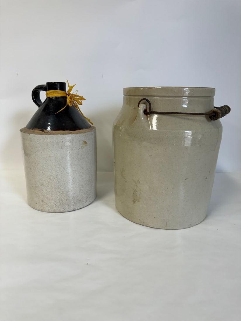 Two(2) Antique Stoneware Crocks: Including: Ring handled jug - 12in.H. x 7in.W.; Pot with wire handle - 12in.H. x 9.5in.W.