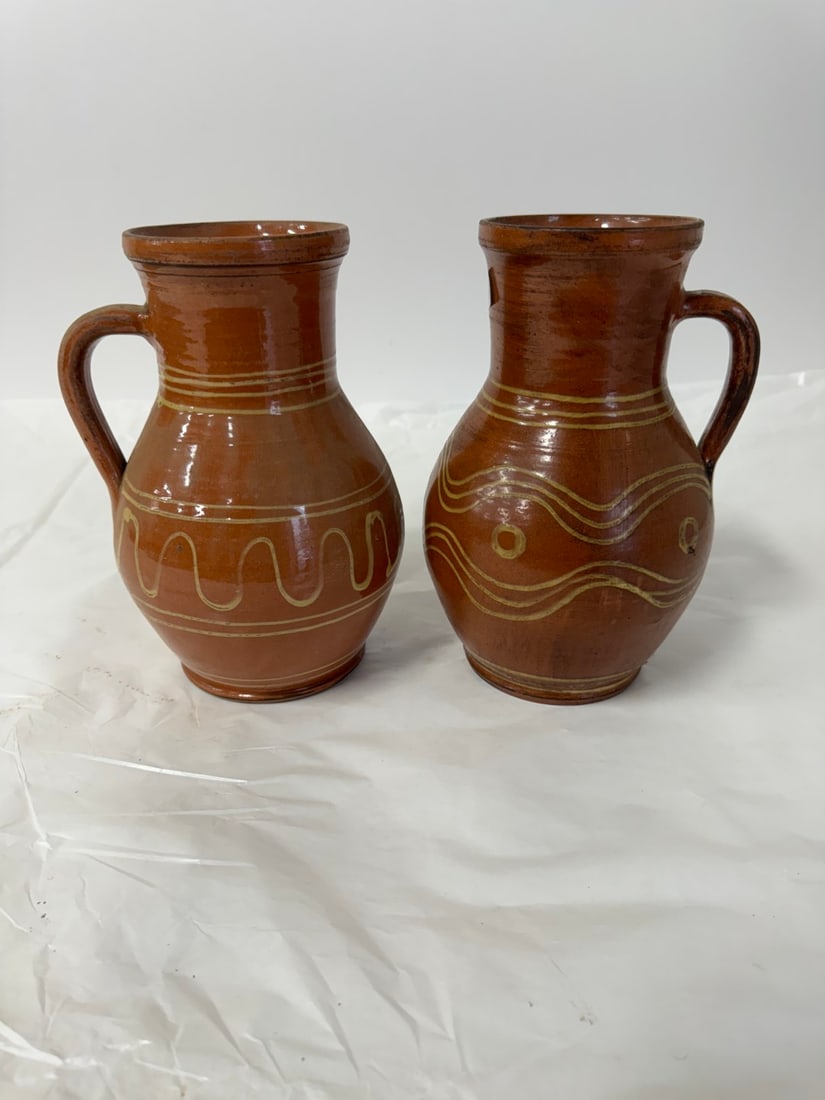 Two(2) Redware Pottery Tankards: Two(2) pottery tankards. Slip decoration; 14in.H.