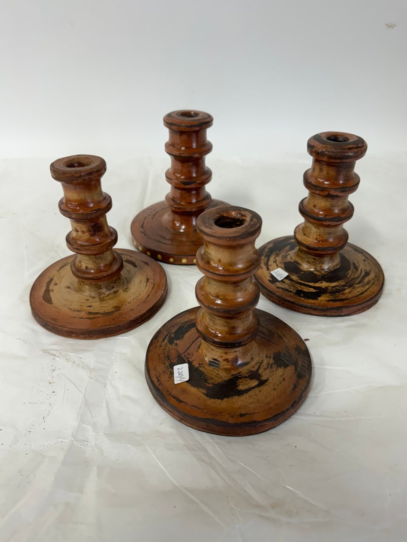 Four(4) Redware Pottery Candlesticks: Glazed pottery candlesticks; 6in. - 7in.H.