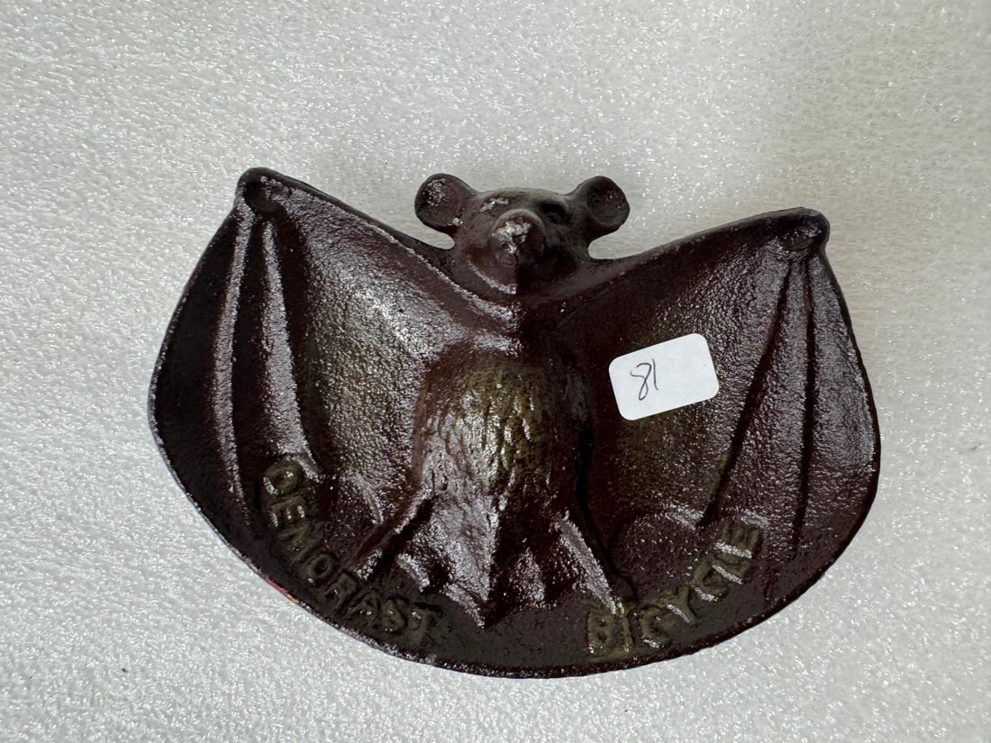 Cast Iron Adv. Tray Demorast Bicycle: In the form of a bat. 3 1/2"H x 5 1/4"W