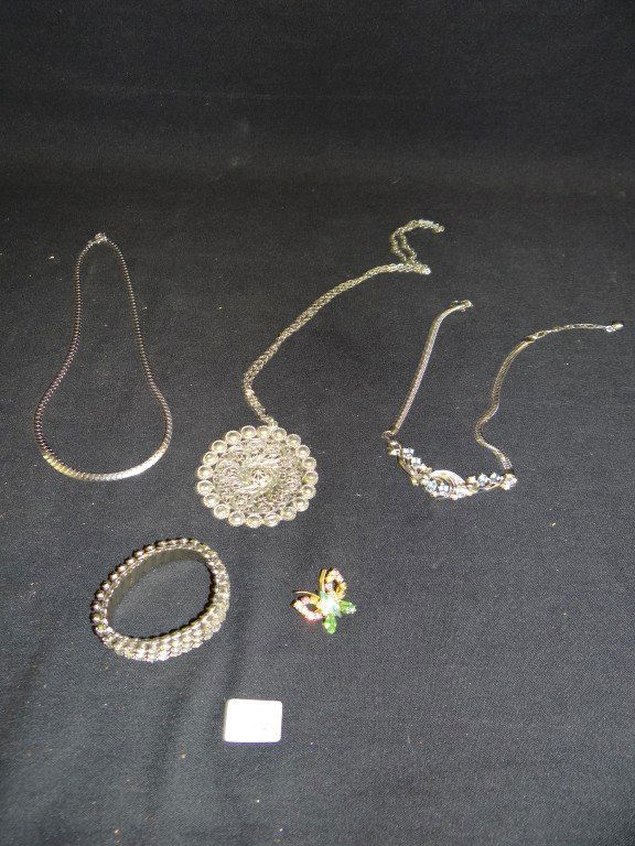 Costume Jewelry Inc. Sterling (7): Sterling silver necklace marked sterling; signed Trifari blue rhinestone necklace; a filigreed necklace with medallion; a Lady Patricia rhinestone expansion bracelet (missing a stone); a colored rhine
