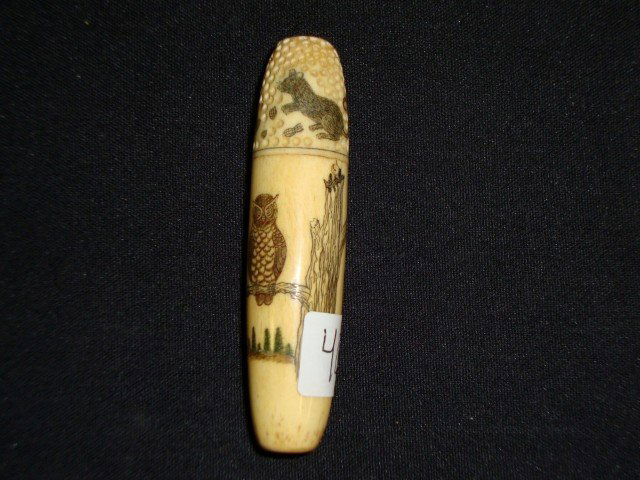 Marine Ivory Needle Case: A thimble unscrews at the top to reveal the needle chamber. The thimble is scrimshaw decorated with a cat and mouse at play. The needle case is scrimshawed with owl on a fence decorations.