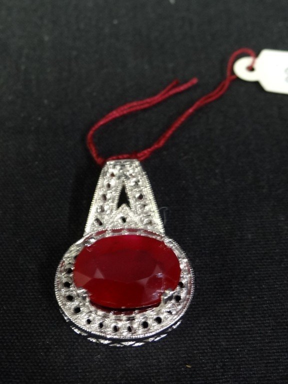 Ruby Pendant 17.64 Carats: In a sterling silver setting, designer ruby and sterling pendant surrounded by diamonds Appraised value $16,800. With certificatle