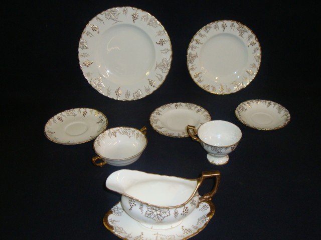 Royal Crown Derby porcelain dinner service: Gold vine pattern. The English dinner service is comprised of: dinner plates-10.25in. D. (12), salad plates(11), bouillons(12, 1 w/rim flake), underplates(12), desserts(12)cups and saucers(12), gravy 