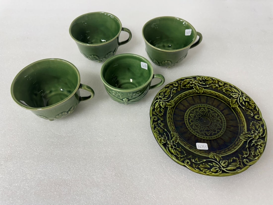 Majolica Pottery (5): Five pcs in the lot. Four cups in the lot marked at the underside, Made in Portugal seemingly marked Bordallo Pin and a second word thats indiscrnible Cups 3"H to 2 3/4"H and the plate is marked Sarre