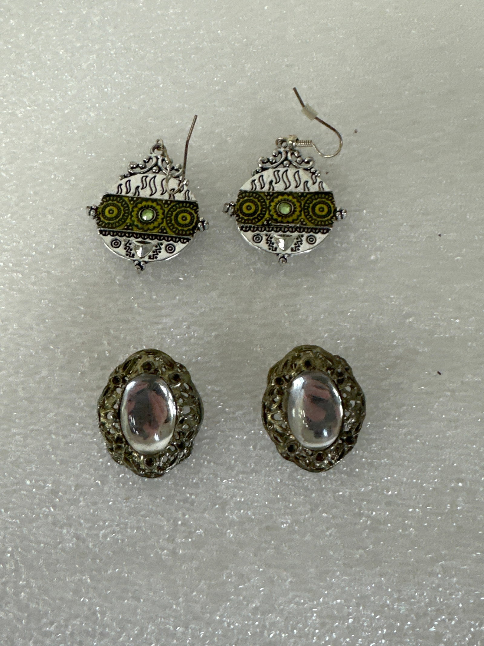 Two Pairs Silver Earrings Moonstone & Peridot: Fancy silver with central green peridot , niello work. The other huge moonstone clip ons appear to be fine silver.