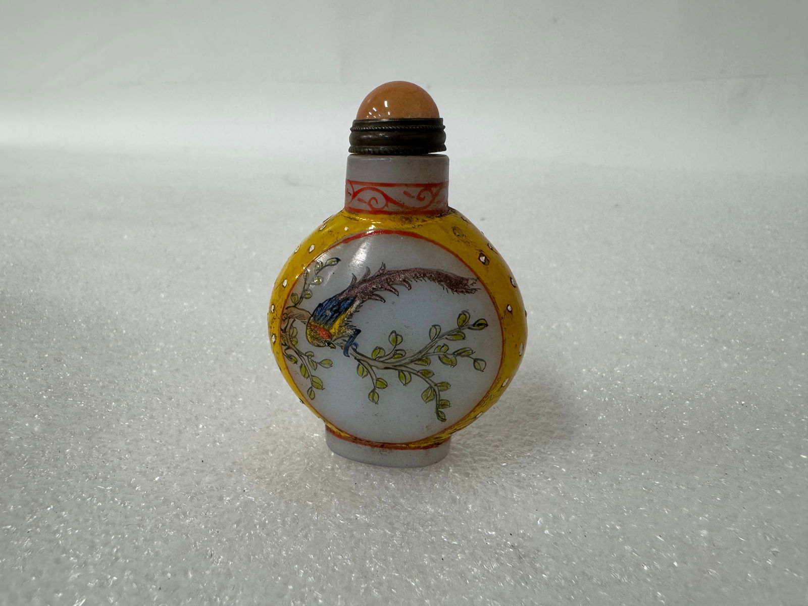 Antique Snuff Bottle: Carnelian colored stopper. Calligraphy mark on the underside