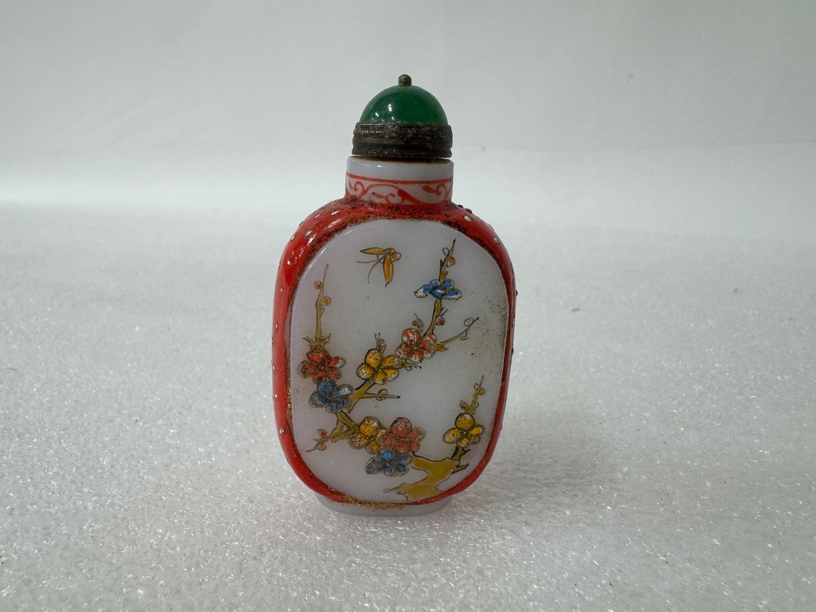 Antique Snuff Bottle: Jade colored stopper. Calligraphy mark at the underside