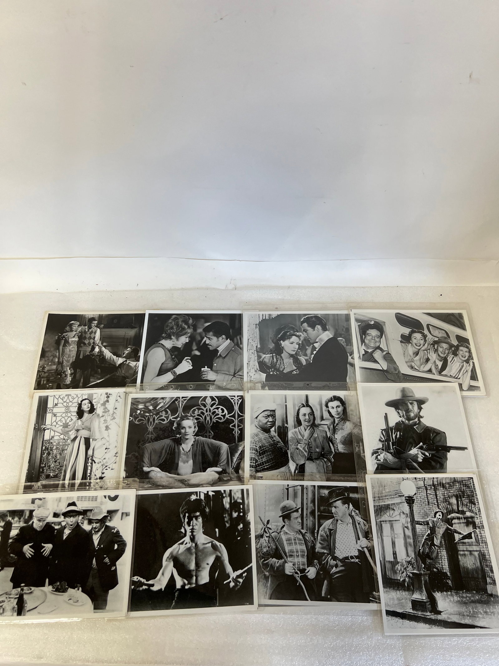 Movie Photographs (30 in the lot): Elizabeth Taylor, Gene Kelly, Bruce Lee lint Eastwood, The Honeymooners, , Marlene Dietrich, a still from Criss Cross, Sammy Davis Jr. and others. 8 x 10