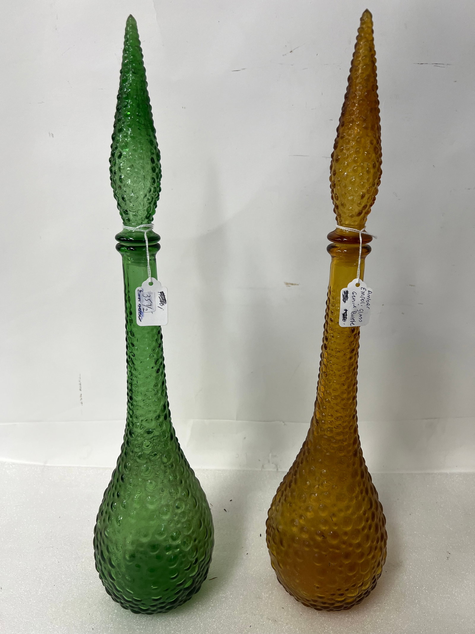 Art Glass Decanters Amber Glass & Green (2): Hobnail variety. With elongated hobnail stoppers 18"H