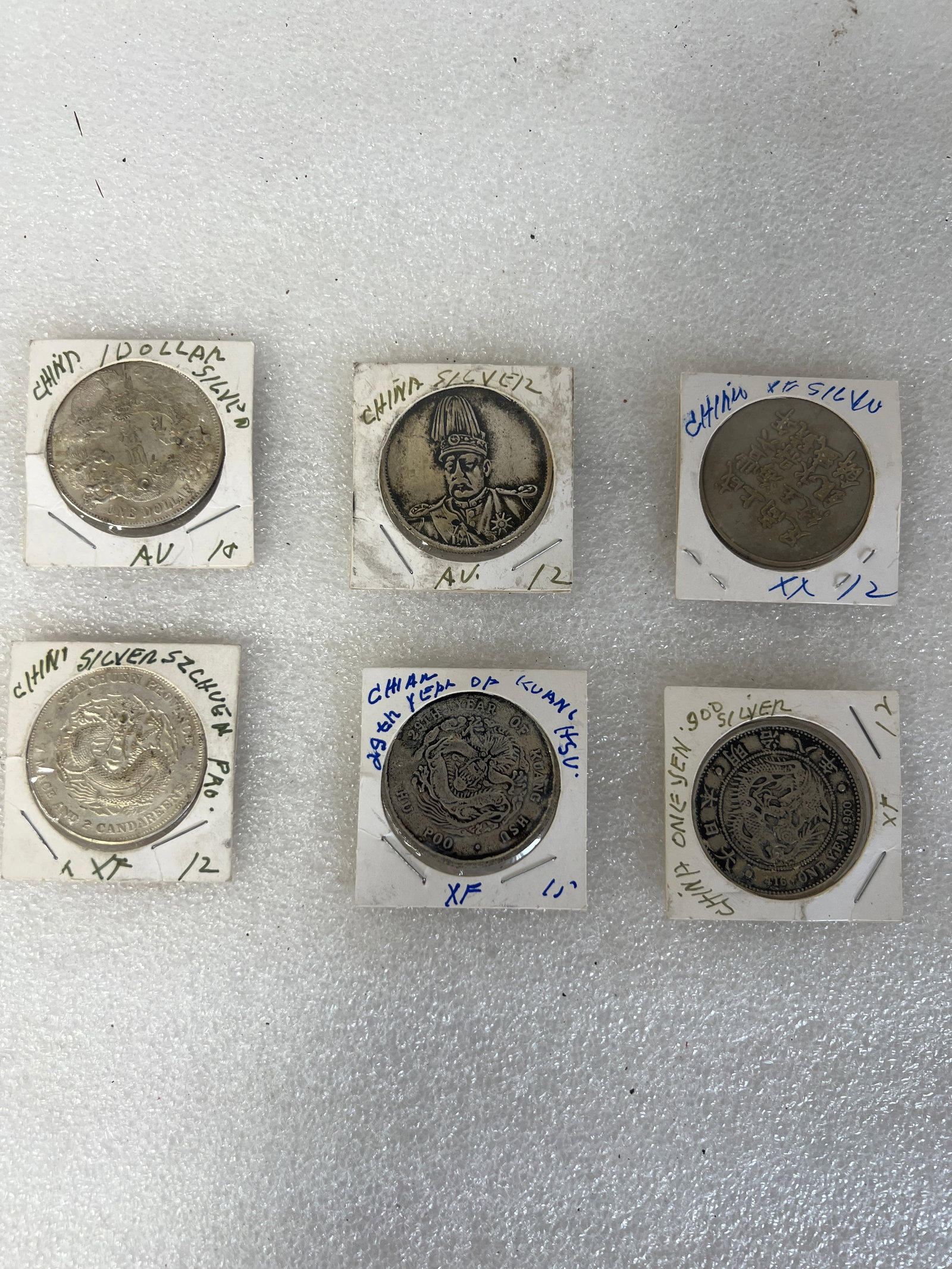 Chinese Coins (6): Includes 1$ Silver and other silver. Can call for additional information that is on the holders. All are in coin holders as pictured. One marked on holder 25th yr. of Kang Hsu.