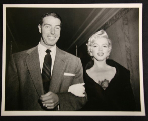 Marilyn Monroe and Joe Dimaggio photograph: Black and White. 1969 United Press International photograph of Marilyn Monroe with Joe DiMaggio with publicity snipe and backstamp. 8 x 10