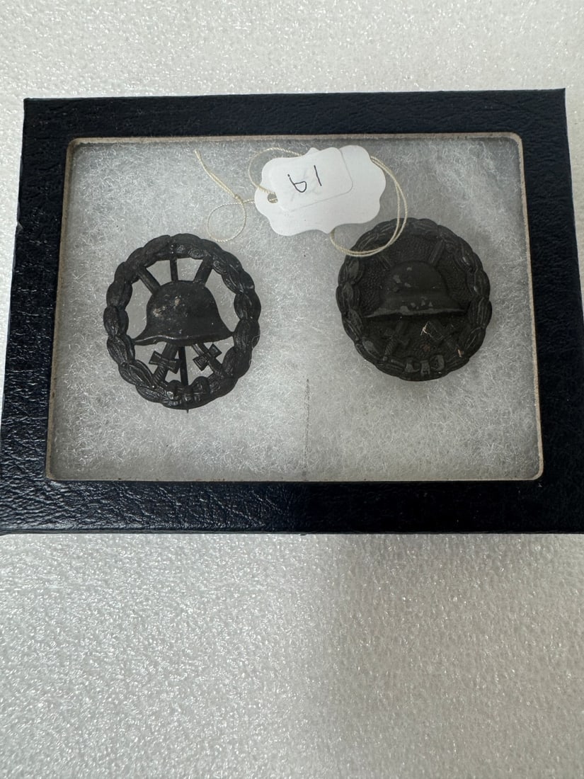 Two WW II Badges: Black for 1-2 wounds. These are two different badge types. One is cut out and one is solid front. Both are hallowed in the back. These are authentic and in excellet condition