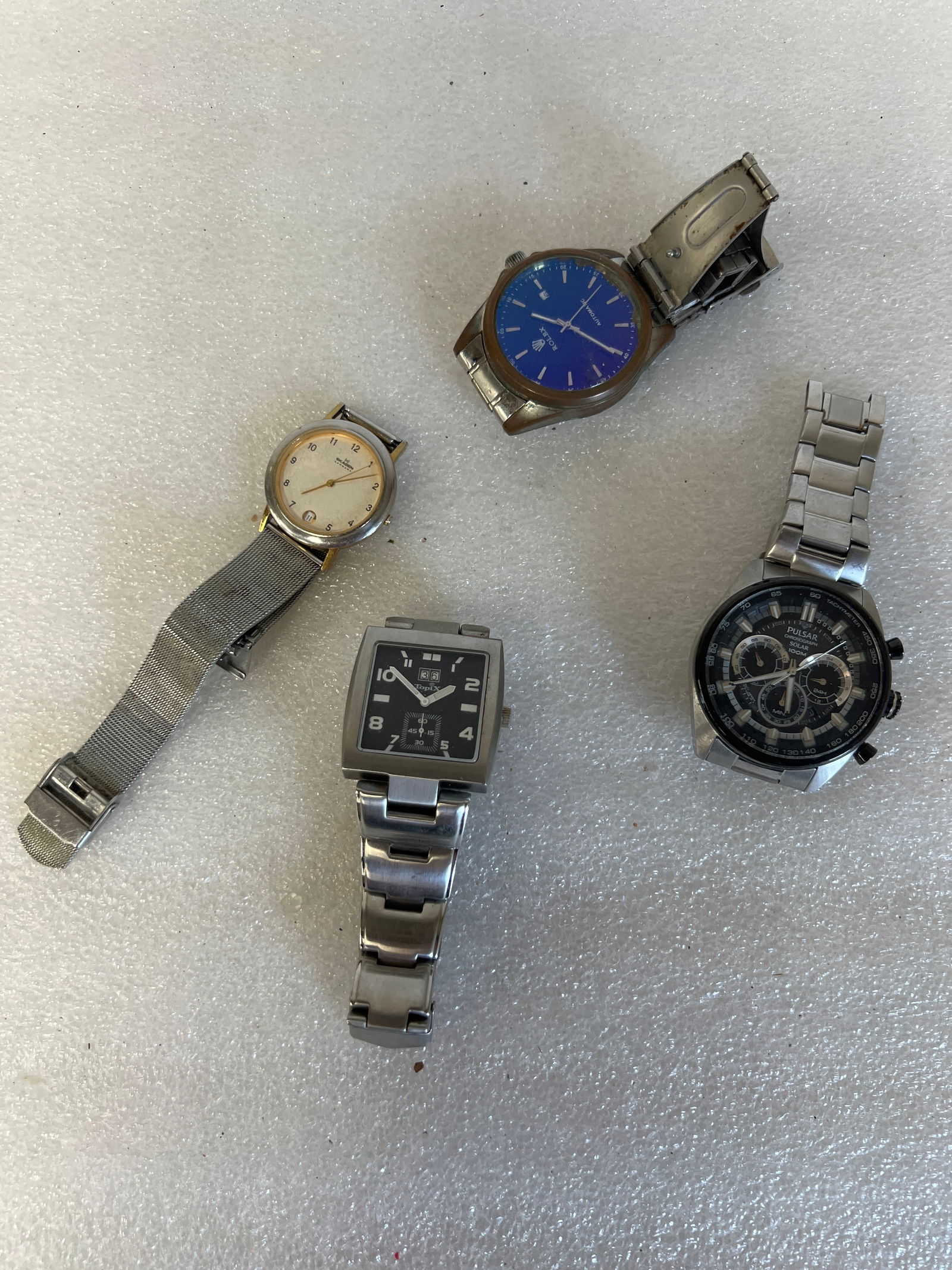 Bag Lot of Men's Wristwatches (4): One marked Rolex , one marked Pulsar and one marked Topix as well as Skagen Four in the lot.