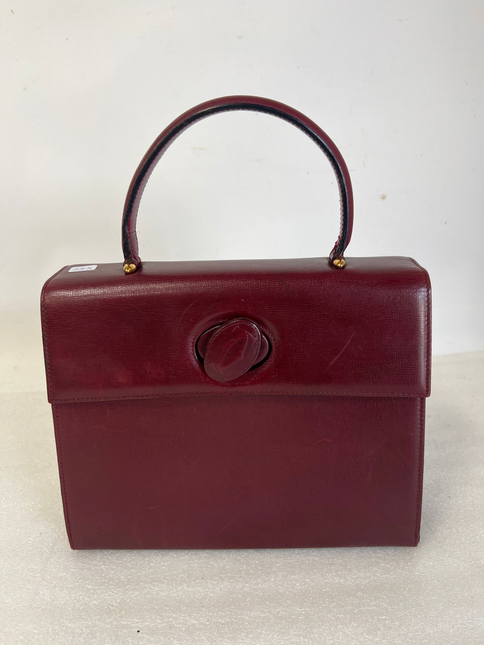 Cartier Kelly Handbag: Marked Cartier Paris at the inside in gold and Cartier Paris in multiple lines at the inside of the zippered compartment. Guarateed original 10.75" W x 8.75"H x 3.5"D