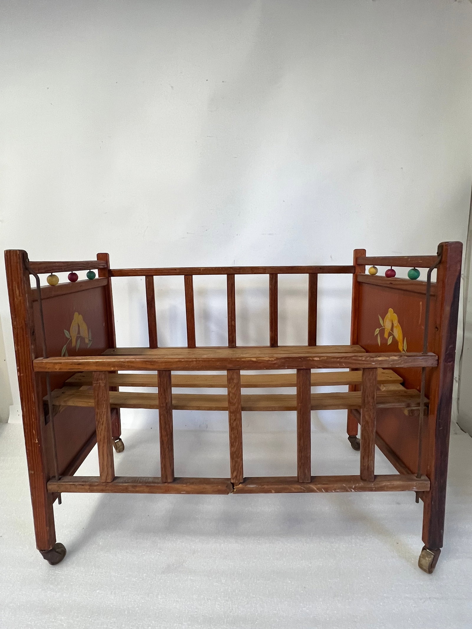 Antique Doll Crib.: Decorated with sleeping gold birds.