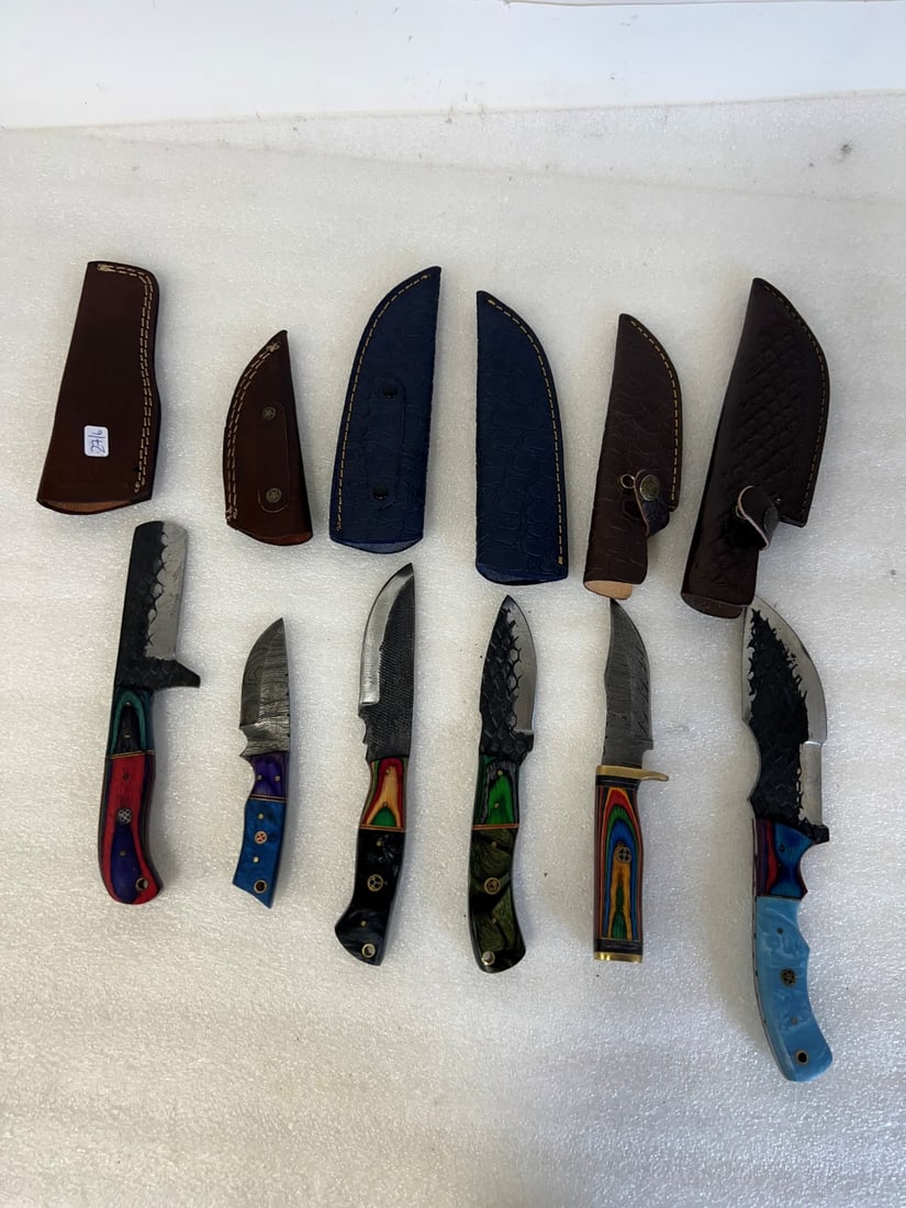 Knives in Sheaths Damascus Blades (6): Various sizes. All in Sheaths. Largest is 10.25"L. Smallest is 6.25"L.