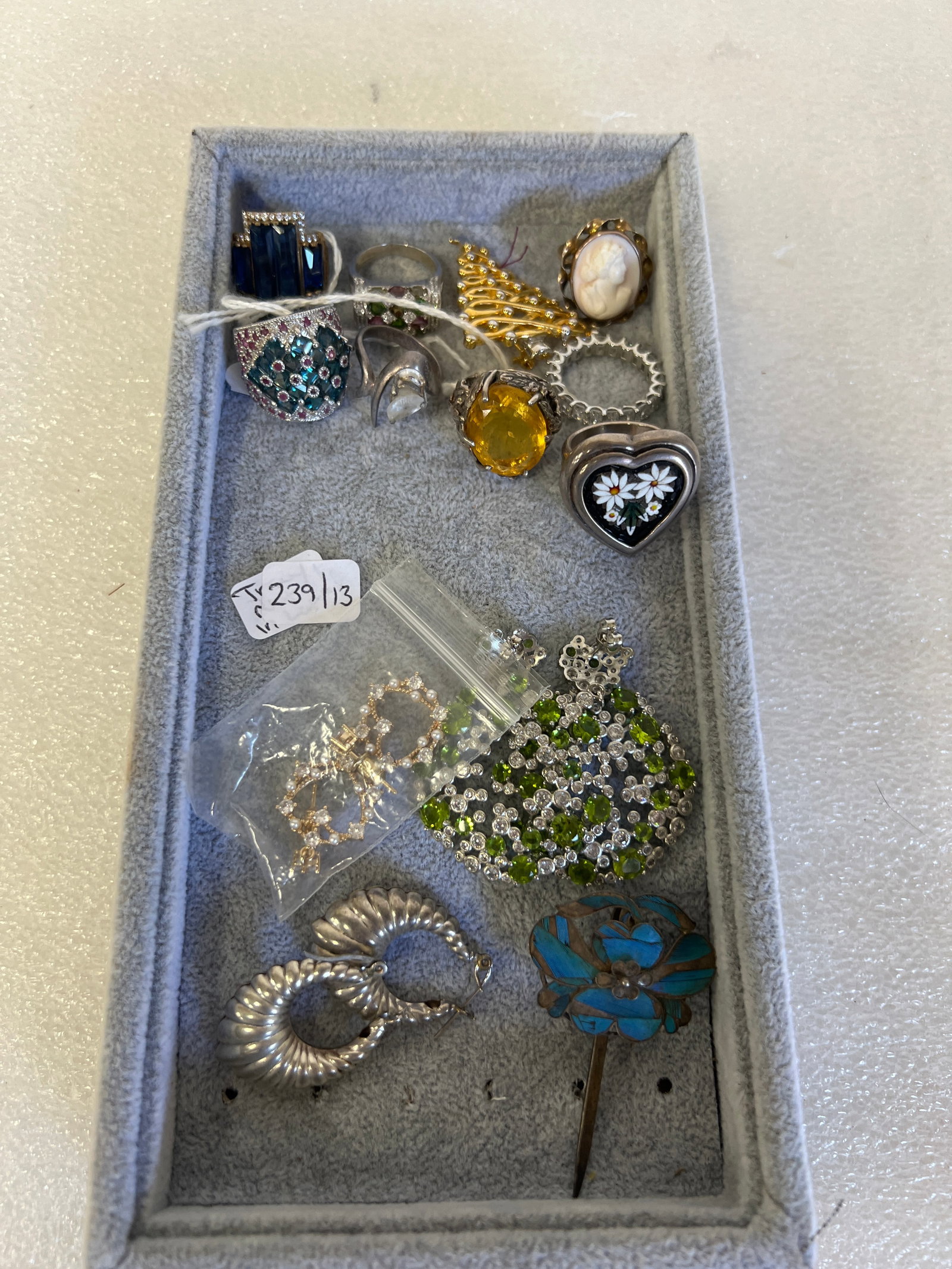 Dealer's Lot of Saleable Vintage Jewelry (13): "Gold " Christmas tree pin ; eight rings; three pr. of earrings all for pierced and an enameled stick pin . 13 pcs. in the lot.