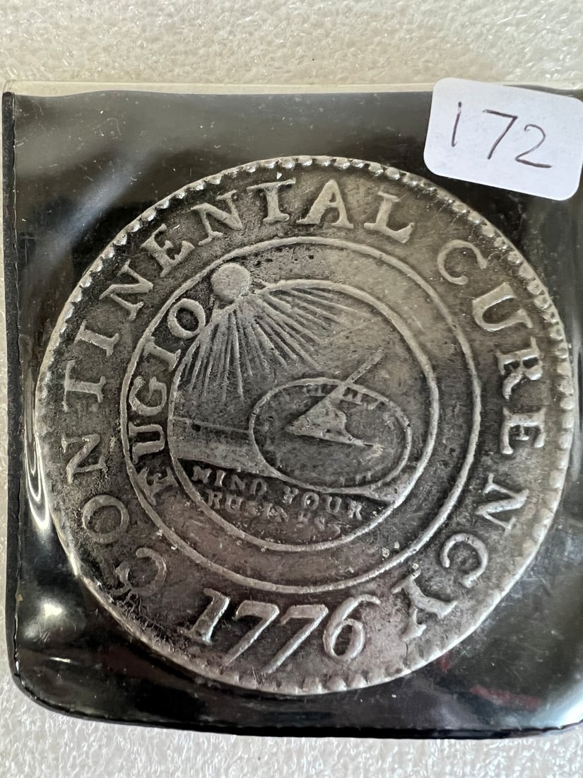 Continental Dollar 1776: Extensive history at the back First Silver Dollar size coin in the US but never circulated. Replica. Original die is in the Smithsonian.