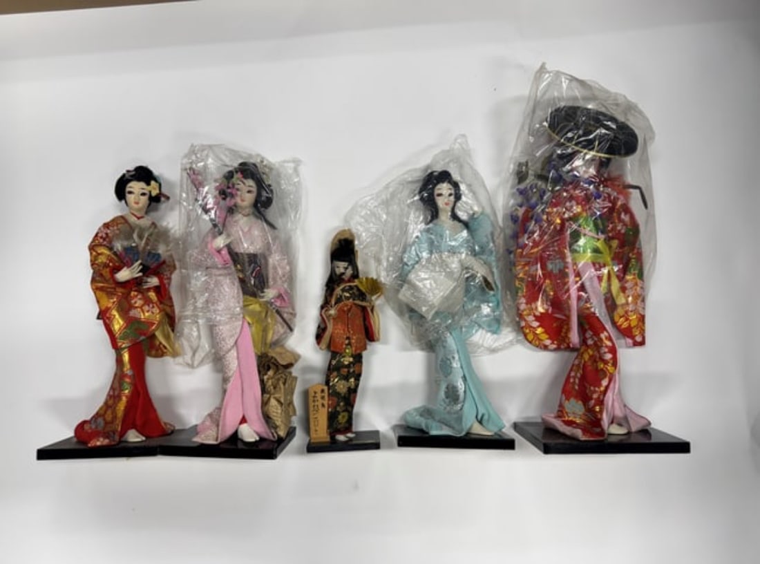 Japanese Dolls ( Five in the lot): Four with porcelain faces and one with a cloth face. . One with cloth face, Snow Queen, 15"H and the four remaining all have porcelain. 12"H (smallest) to 19"H (largest )