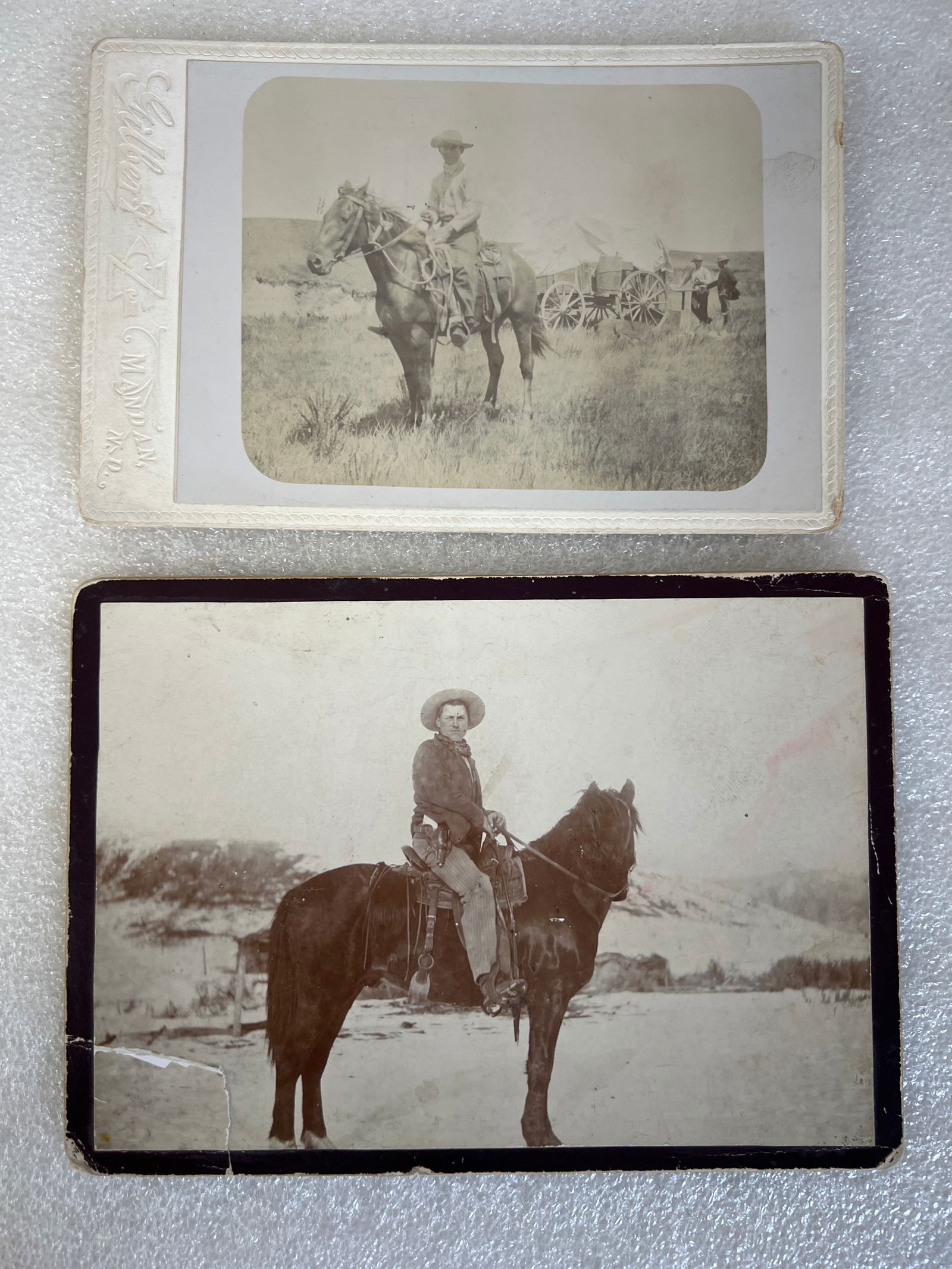 Early Cowboy Photographs (2): Cowboys on Horseback. Both on cardboard. One with early Eastman Kodak markings. 5" x 7" and 4" x 6"