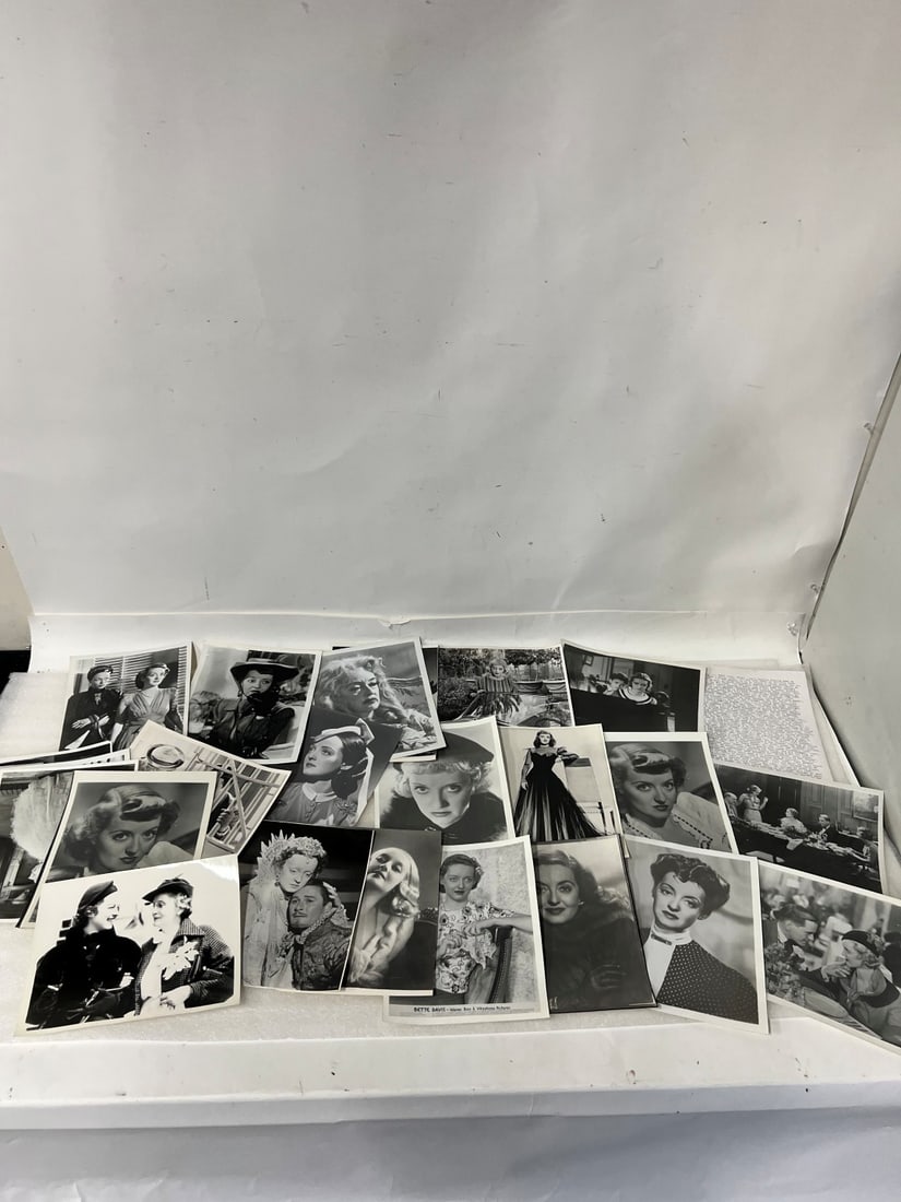Bette Davis Movie Photos (25): All black and white. Mostly 8 x 10 Includes printed list of her movies, the scenes depicted in the photographs, the year, the co-stars etc.