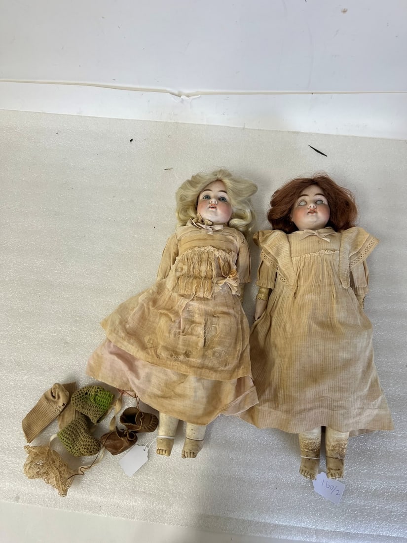 Bisque Head Antique Dolls (2): Victorian German Bisque Dolls. with kid bodies, both marked 154 Dep 6 . One doll with fixed blue eyes, open mouth, teeth and hand painted facial features. Original clothing, socks and shoes. No damage