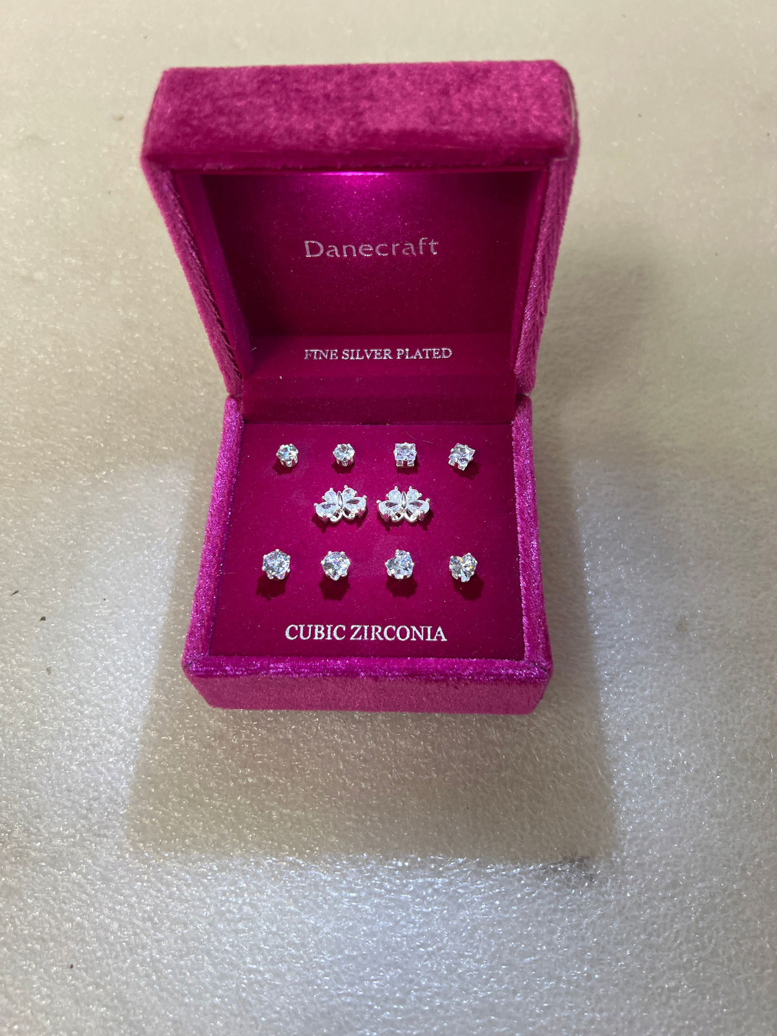 Danecraft Cubic Zirconia Silverplated Earrings ( 5 pr.): Various sizes. Various styles All for pierced. Five pr. in the original Danecraft fitted box which when opened has an interior light which comes on accentuating what's on the box.