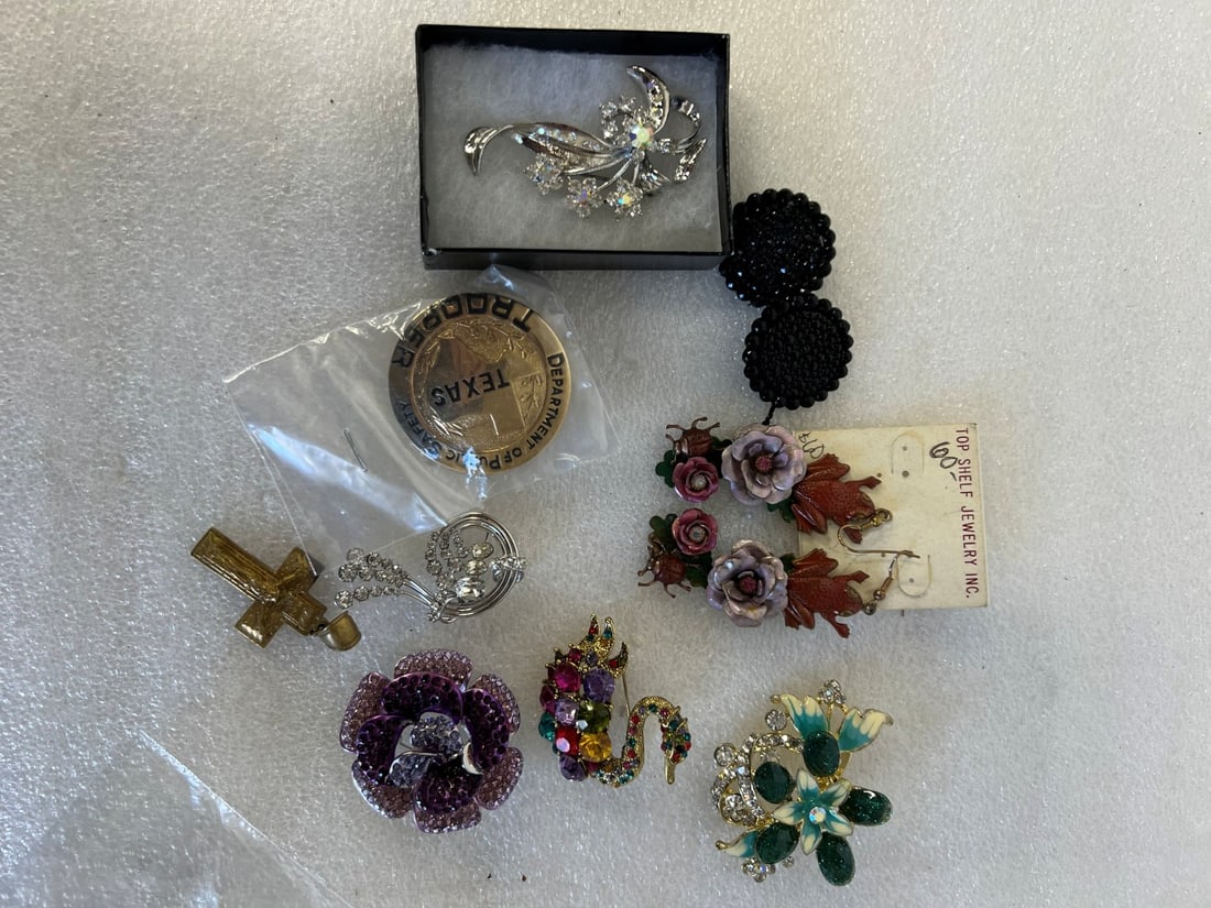 Diverse Lot Vintage Jewelry(9): Diverse Lot of Vintage Costume Jewelry. Inc in the lot are several sgd brooches inc. one marked Sterling, (5); a pr. of black jade buttons Top Shelf Jewelry earrings for pierced with frogs and flowers